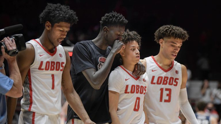 From left: New Mexico's Saquan Singleton, Birima Seck, KJ Jenkins(Cq) and Javonte Johnson walk off the floor in dejection after a loss to Utah State in overtime of an NCAA college basketball game Saturday, Jan. 8, 2022 at the Pit in Albuquerque, N.M. (Roberto E. Rosales/The Albuquerque Journal via AP)