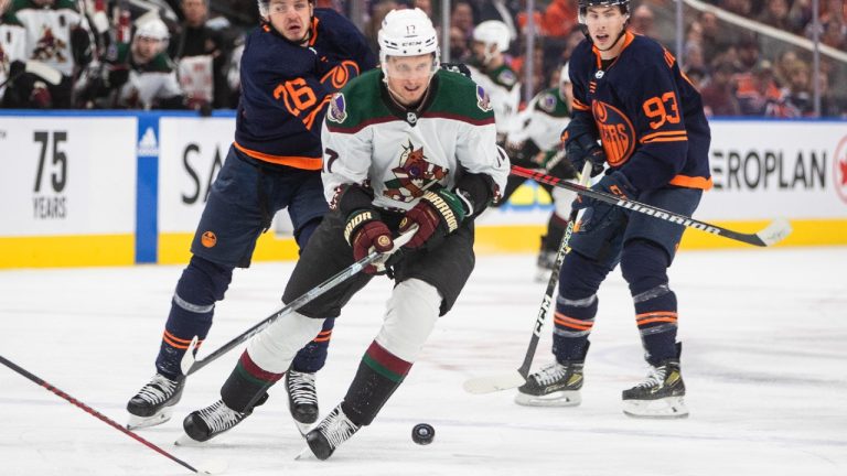 Arizona Coyotes' Nick Bjugstad (17) is chased by Edmonton Oilers' Mattias Janmark (26) and Ryan Nugent-Hopkins (93) during first period NHL action in Edmonton on Wednesday, December 7, 2022. (Jason Franson/CP)