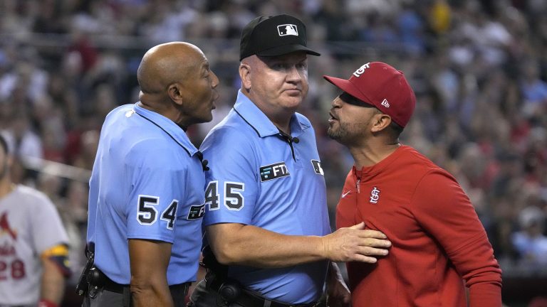 St. Louis Cardinals manager Oliver Marmol, right, is restrained by MLB umpire Jeff Nelson (45) while talking to CB Bucknor (54) in the third inning during a baseball game against the Arizona Diamondbacks, Sunday, Aug. 21, 2022, in Phoenix. Marmol was ejected from the game. (Rick Scuteri/AP)