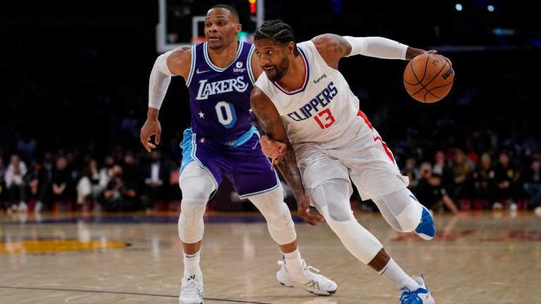 Los Angeles Lakers guard Russell Westbrook (0) defends against Los Angeles Clippers guard Paul George (13) during the first half of an NBA basketball game in Los Angeles, Friday, Dec. 3, 2021. (Ashley Landis/AP)