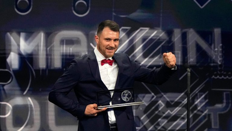 Polish amputee soccer player Marcin Oleksy receives the FIFA Puskas Award for the best goal during the ceremony of the Best FIFA Football Awards in Paris, France, Monday, Feb. 27, 2023. (Michel Euler/AP)