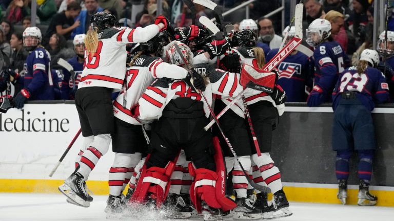 Canada players celebrate after a goal by Danielle Serdchny during overtime of a Rivalry Series hockey game against the United States Monday, Dec. 19, 2022, in Los Angeles. Canada won 3-2. (Ashley Landis/AP)