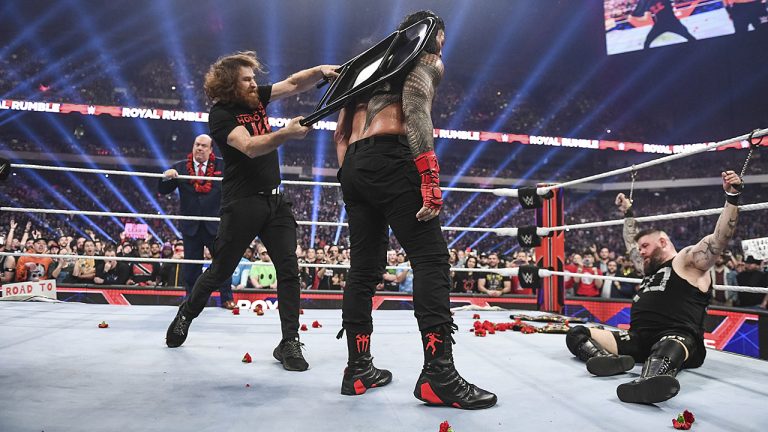 Sami Zayn hits Roman Reigns with a chair in the aftermath of the champion’s match with Kevin Owens at Royal Rumble. (WWE)