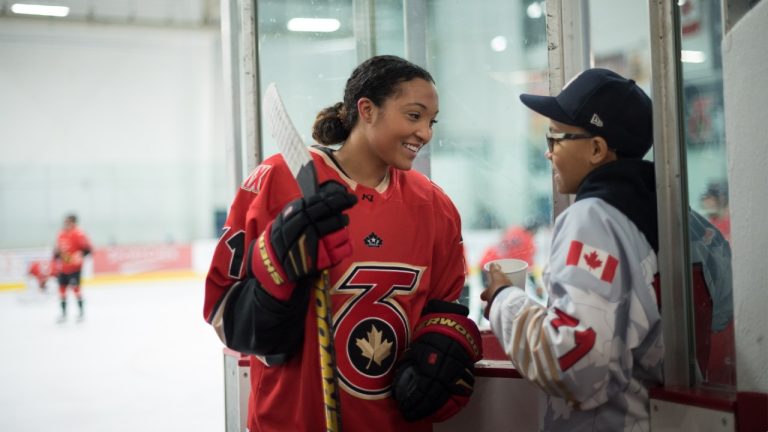 Saroya Tinker of the Toronto Six of the Premier Hockey Federation is greeted by her brother Malachi, 12, after an on-ice warm-up before a home game against the Connecticut Whale. (Tijana Martin/CP)