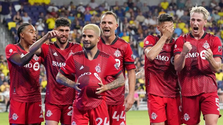 Toronto FC's Lorenzo Insigne holds the ball under his shirt as he celebrates with his teammates after scoring a goal against Nashville SC during the second half of an MLS soccer match Saturday, Aug. 6, 2022, in Nashville, Tenn. (Mark Humphrey/AP Photo)