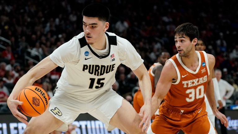 Purdue's Zach Edey gets past Texas's Brock Cunningham during the first half of a second-round NCAA college basketball tournament game Sunday, March 20, 2022, in Milwaukee. (Morry Gash/AP)