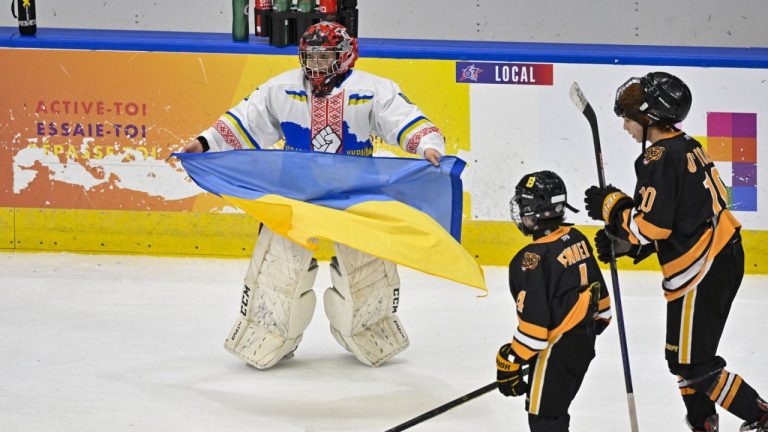 The Ukraine Selects team have spent a special time in Canada since the start of the Quebec Peewee Tournament. Ukraine peewee team goalie Dmytro Korzh, left, celebrates his team's victory by holding the Ukraine flag as Boston Junior Bruins Patrick Fennell and Brendan O'Toole skate by at the end of the game, Saturday, February 11, 2023 at Quebec’s international peewee tournament in Quebec City. (Jacques Boissinot/CP)