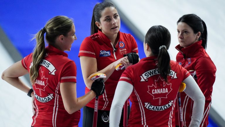 Team Canada lead Briane Harris, from left to right, second Shannon Birchard, third Val Sweeting and skip Kerri Einarson talk after scoring 4 against Quebec in the 8th end at the Scotties Tournament of Hearts, in Kamloops, B.C., on Friday, February 17, 2023. (Darryl Dyck/CP)