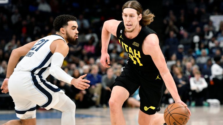 Utah Jazz forward Kelly Olynyk drives against Memphis Grizzlies guard Tyus Jones (21) in the first half of an NBA basketball game, Sunday, Jan. 8, 2023, in Memphis, Tenn. (Brandon Dill/AP)