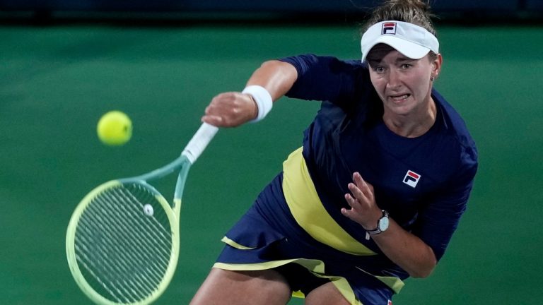 Czech Republic's Barbora Krejcikova returns the ball to Poland's Iga Swiatek during their final match of the Dubai Duty Free Tennis Championships in Dubai, United Arab Emirates, Saturday, Feb 25, 2023. (AP)