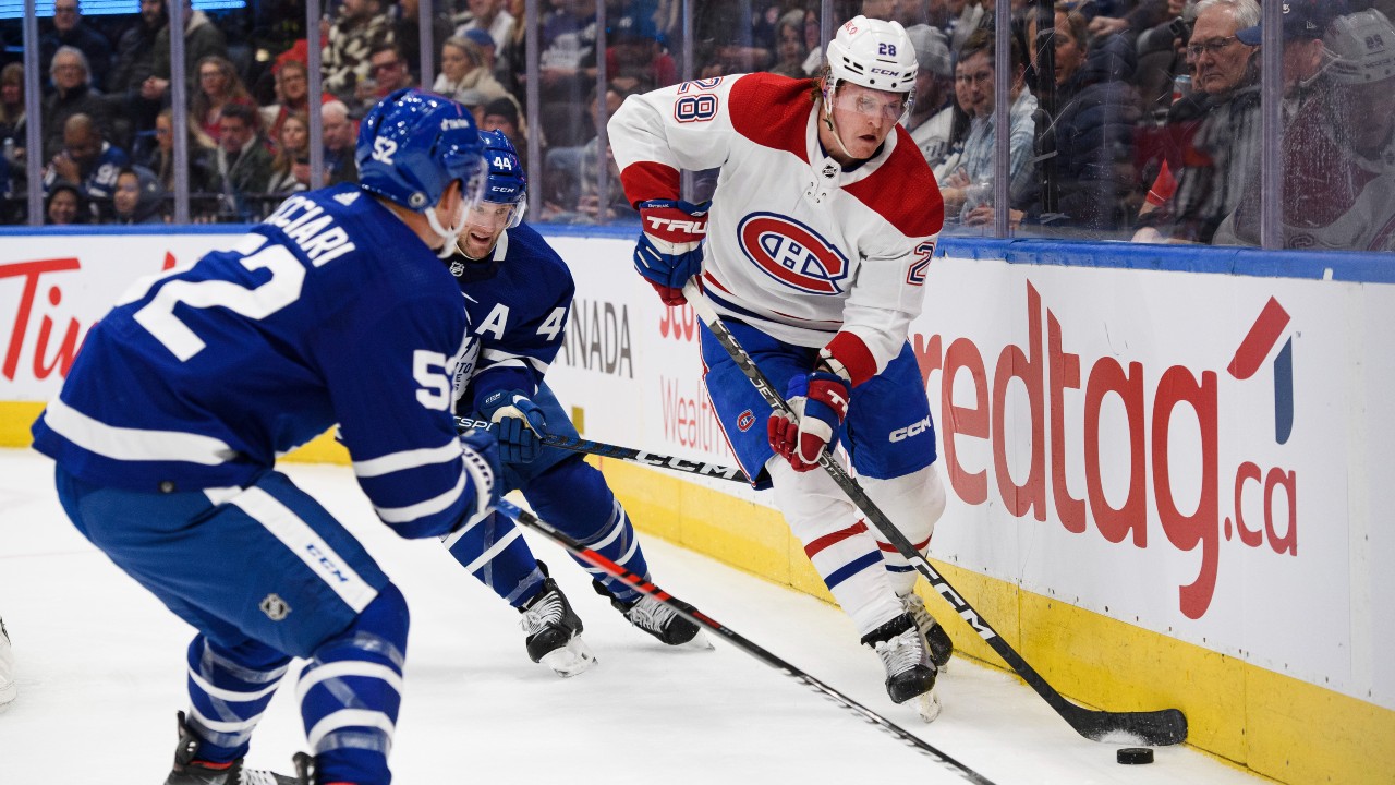 Toronto Maple Leafs' Auston Matthews (34) celebrates scoring his team's  fourth goal with teammate John Tavares, left, as Mitchell Marner skates in  during second period NHL hockey action against the Minnesota Wild