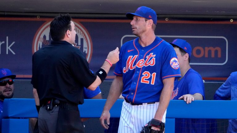 New York Mets starting pitcher Max Scherzer (21) talks with home plate umpire David Rackley after working during the second inning of a spring training baseball game against the Washington Nationals. (Jeff Roberson/AP)