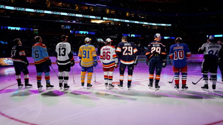 NHL hockey players stand before they are introduced before the NHL All Star Skills Showcase. (Lynne Sladky/AP)