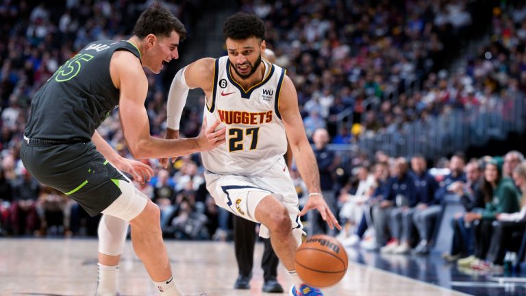 Denver Nuggets guard Jamal Murray, right, drives past Minnesota Timberwolves center Luka Garza during the second half of an NBA basketball game. (David Zalubowski/AP)