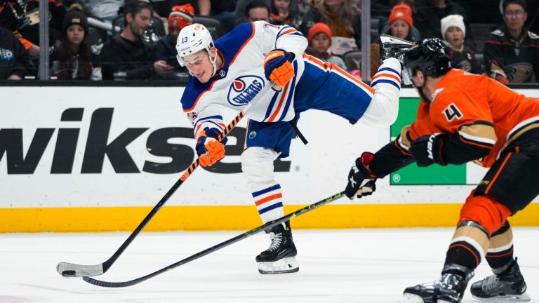 Edmonton Oilers' Jesse Puljujarvi (13) shoots as he is pressured by Anaheim Ducks' Cam Fowler (4) during the second period of an NHL hockey game Wednesday, Jan. 11, 2023, in Anaheim, Calif. (Jae C. Hong/AP)