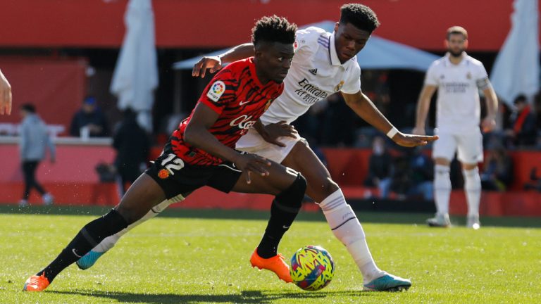 Real Madrid's Aurelien Tchouameni challenges for the ball with Mallorca's Iddrisu Baba, left, during a Spanish La Liga soccer match between Mallorca and Real Madrid at the Son Moix stadium in Palma de Mallorca, Spain, Sunday, Feb. 5, 2023. (Francisco Ubilla/AP) 