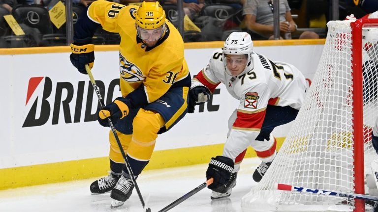 Nashville Predators left wing Cole Smith (36) and Florida Panthers defenseman Santtu Kinnunen (75) chase the puck during the second period of an NHL preseason hockey game Monday, Sept. 26, 2022, in Nashville, Tenn. (Mark Zaleski/AP)