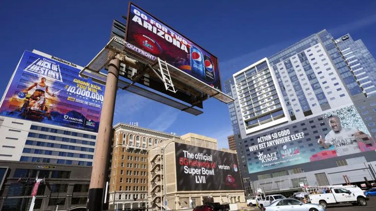 Large advertisements adorn buildings and electronic billboards leading up to the NFL Super Bowl LVII football game. (Ross D. Franklin/AP)