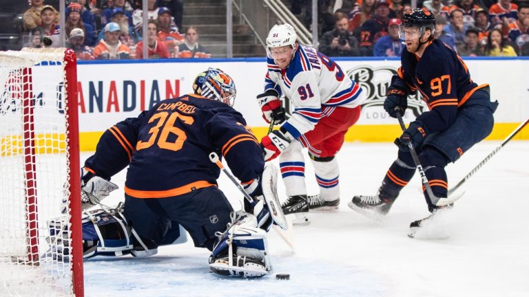 New York Rangers' Vladimir Tarasenko (91) is stopped by Edmonton Oilers' goalie Jack Campbell (36) as Connor McDavid (97) defends during first period NHL action in Edmonton on Friday February 17, 2023. (Jason Franson/CP)