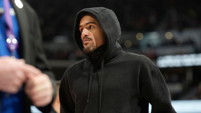 Atlanta Hawks guard Trae Young, who sat out the contest, looks on during a timeout in the second half of an NBA basketball game against the Denver Nuggets, Saturday, Feb. 4, 2023, in Denver. (David Zalubowski/AP Photo)