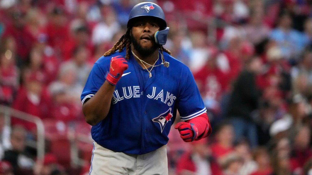 Toronto Blue Jays bench coach Don Mattingly, left, talks with first baseman  Vladimir Guerrero Jr. during