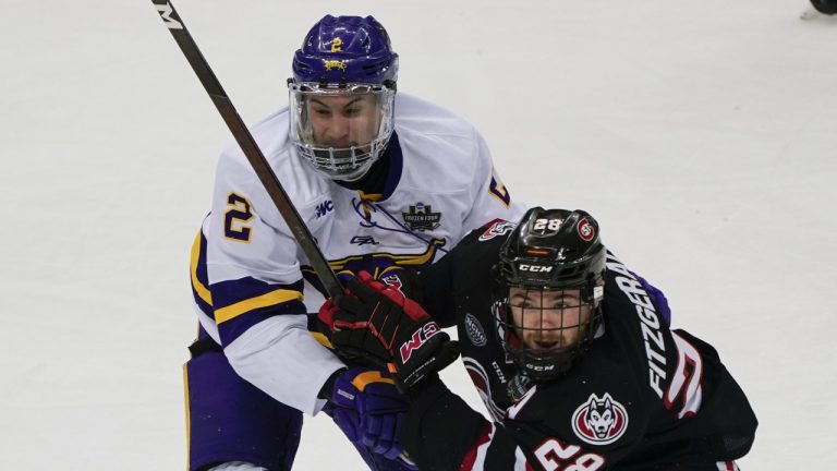 Minnesota State's Akito Hirose (2) and St. Cloud State's Kevin Fitzgerald (28) watch the puck during the third period of an NCAA men's Frozen Four hockey semifinal in Pittsburgh, Thursday, April 8, 2021. St. Cloud State won 5-4 to advance to the championship game Saturday. (Keith Srakocic/AP)