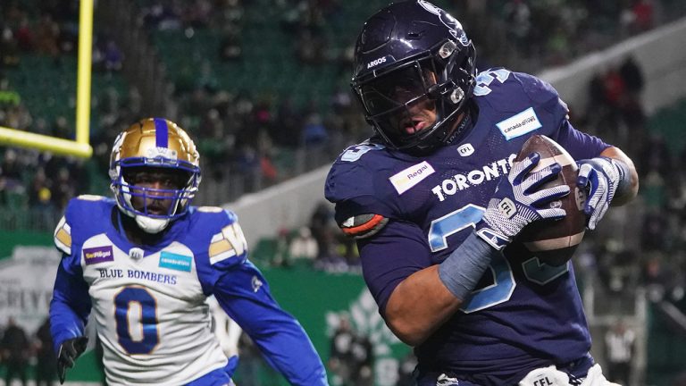 Toronto Argonauts running back Andrew Harris runs the ball as Winnipeg Blue Bombers linebacker Malik Clements defends during second half football action in the 109th Grey Cup at Mosaic Stadium in Regina, Sunday, Nov. 20, 2022. (Heywood Yu/CP)