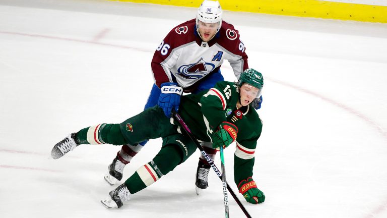 Minnesota Wild left wing Matt Boldy and Colorado Avalanche right wing Mikko Rantanen compete for the puck during the third period of an NHL hockey game Wednesday, Feb. 15, 2023, in St. Paul, Minn. (Andy Clayton-King/AP)