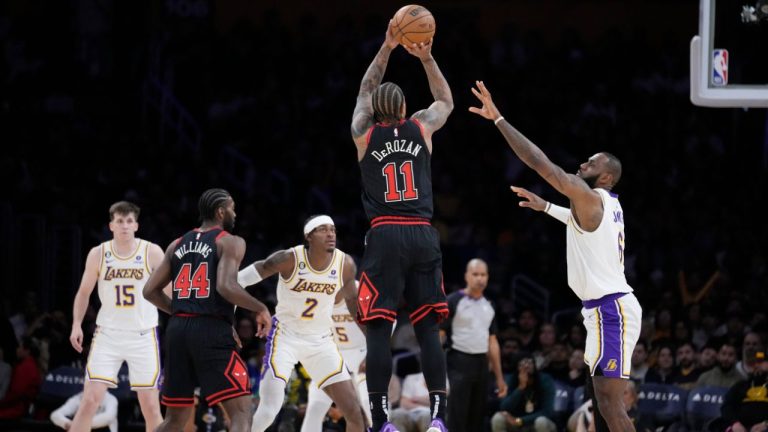 Chicago Bulls forward DeMar DeRozan makes a 3-point basket over Los Angeles Lakers forward LeBron James during the second half of an NBA basketball game, Sunday, March 26, 2023, in Los Angeles. (Marcio Jose Sanchez/AP Photo)