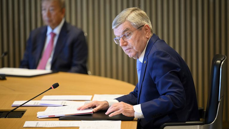 International Olympic Committee (IOC) President Thomas Bach, right, speaks at the opening of the executive board meeting of the International Olympic Committee  in Lausanne, Switzerland, Tuesday, March 28, 2023. (Laurent Gillieron/Keystone via AP)