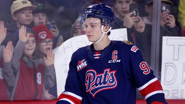 Regina Pats player Connor Bedard gets fan attention prior to a WHL (Western Hockey League) game against the Calgary Hitmen in Calgary, Alta., Wednesday, Feb. 1, 2023. (Larry MacDougal/CP)