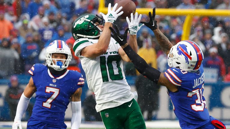 New York Jets wide receiver Braxton Berrios reaches for the ball under pressure from Buffalo Bills cornerback Taron Johnson  and Bills cornerback Dane Jackson during the second half of an NFL football game, Sunday, Dec. 11, 2022, in Orchard Park, N.Y. (Jeffrey T. Barnes/AP)