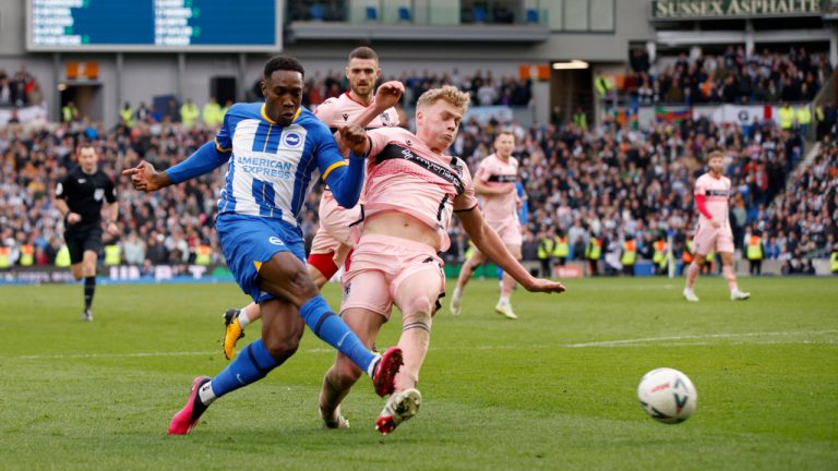 Brighton's Danny Welbeck, left, attempts a shot at goal past Grimsby Town's Andy Smith during the English FA Cup quarterfinals soccer match between Brighton &amp; Hove Albion and Grimsby Town at the AMEX Stadium in Brighton, England, Sunday, March 19, 2023. (David Cliff/AP)