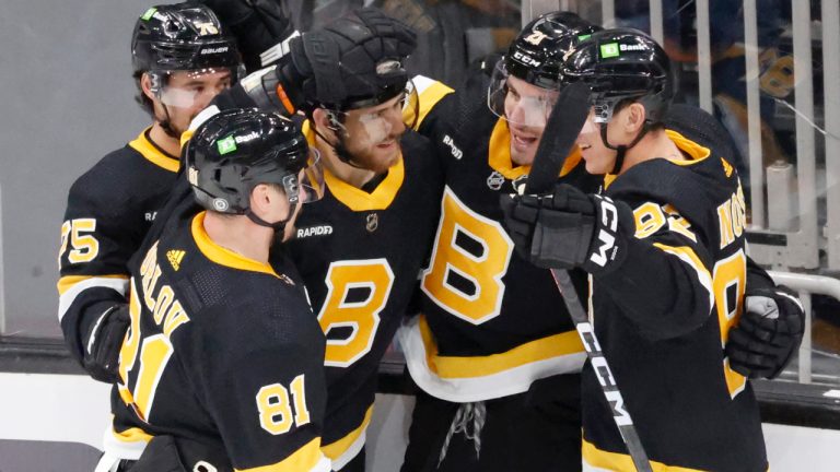 Boston Bruins players congratulate teammate Garnet Hathaway (21) after he scored the game-winning goal against the Detroit Red Wings during the third period of an NHL hockey game, Saturday, March 11, 2023, in Boston. (Mary Schwalm/AP)