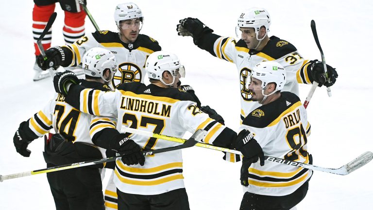 Boston Bruins defenseman Hampus Lindholm (27) celebrates with teammates after scoring a goal during the second period of an NHL hockey game against the Chicago Blackhawks, Tuesday, March 14, 2023, in Chicago. (Matt Marton/AP)