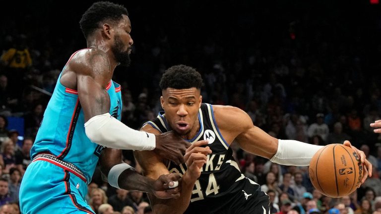 Milwaukee Bucks forward Giannis Antetokounmpo drives against Phoenix Suns center Deandre Ayton during the first half of an NBA basketball game Tuesday, March 14, 2023, in Phoenix. (Rick Scuteri/AP Photo)