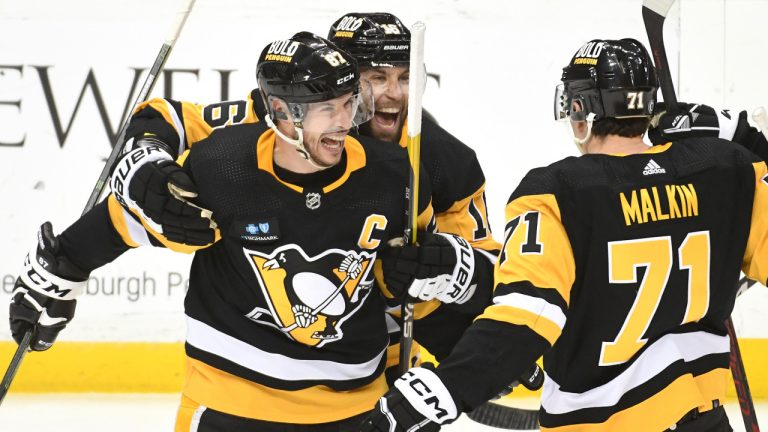 Pittsburgh Penguins center Sidney Crosby (87) celebrates his overtime goal against the Columbus Blue Jackets with left wing Jason Zucker (16) and center Evgeni Malkin (71) during an NHL hockey game, Tuesday, March 7, 2023, in Pittsburgh. The Penguins won 5-4. (Philip G. Pavely/AP) 