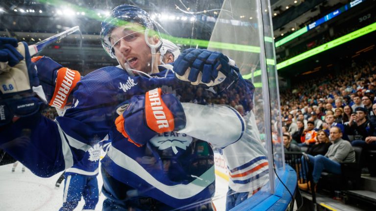 Toronto Maple Leafs left wing Michael Bunting (58) is pinned to the boards during third period NHL hockey action against the Edmonton Oilers in Toronto on Saturday, Mar. 11, 2023. (Cole Burston/CP)