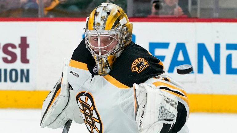 Boston Bruins goaltender Jeremy Swayman (1) deflects a Detroit Red Wings shot in the first period of an NHL hockey game Sunday, March 12, 2023, in Detroit. (Paul Sancya/AP) 