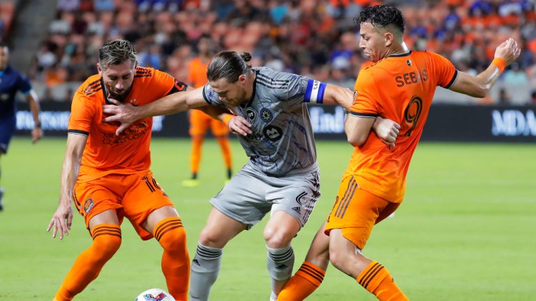 CF Montreal midfielder Samuel Piette, middle, pushes off Houston Dynamo midfielder Hector Herrera, left, and forward Sebastian Ferreira (9) during the second half of an MLS soccer match Saturday, Aug. 13, 2022, in Houston. (Michael Wyke/AP)