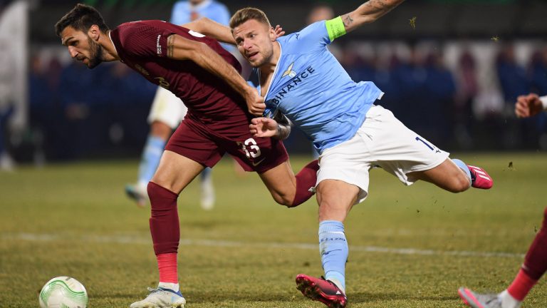 CFR's Denis Kolinger, left, challenges for the ball with Lazio's Ciro Immobile during the Europa Conference League playoff second leg soccer match between CFR Cluj and Lazio, at the Constantin Radulescu Stadium in Cluj, Romania, Thursday, Feb. 23, 2023. (Raed Krishan/AP) 