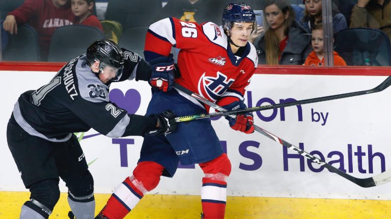 Former Lethbridge Hurricanes player Chase Wheatcroft, right, plays against Calgary Hitmen player Riley Fiddler-Schultz during WHL (Western Hockey League) hockey action in Calgary, Alta., on Sun., Feb.9, 2020. (Larry MacDougal/CP)