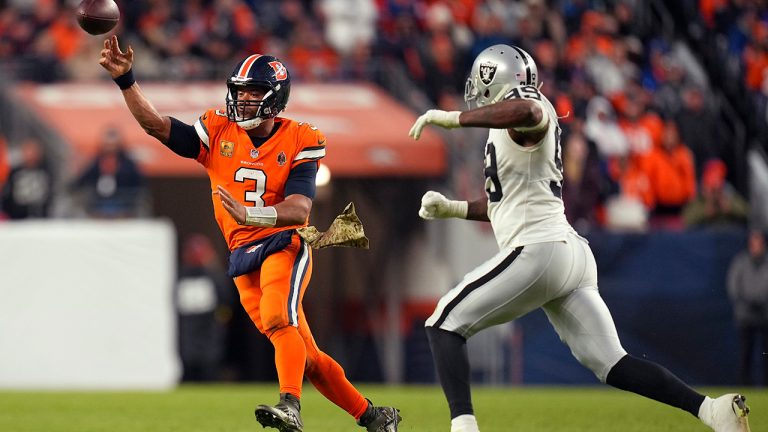 Denver Broncos quarterback Russell Wilson passes against Las Vegas Raiders defensive end Clelin Ferrell during the second half of an NFL football game in Denver, Sunday, Nov. 20, 2022. (Jack Dempsey/AP)