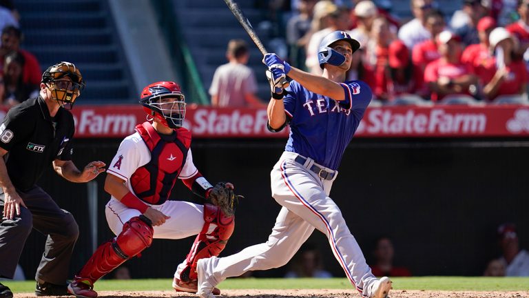 Texas Rangers' Corey Seager, right, hits a home run during the fifth inning of a baseball game against the Los Angeles Angels in Anaheim, Calif., Sunday, Oct. 2, 2022. (Ashley Landis/AP)