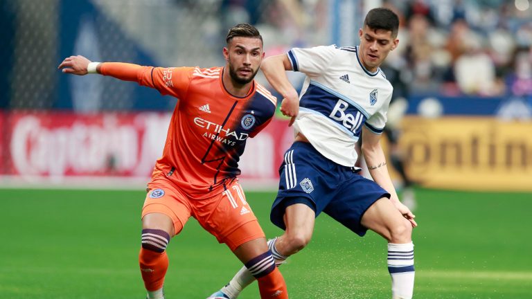 New York City FC's Valentin Castellanos and Vancouver Whitecaps' Cristian Gutierrez battle for a loose ball during first half MLS soccer game action in Vancouver on Saturday, March 5, 2022. (Jeff Vinnick/CP)