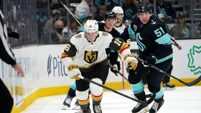 Vegas Golden Knights' Pavel Dorofeyev, left, skates ahead of Seattle Kraken's Derrick Pouliot during the first period of an NHL hockey game Friday, April 1, 2022, in Seattle. (Elaine Thompson /AP)