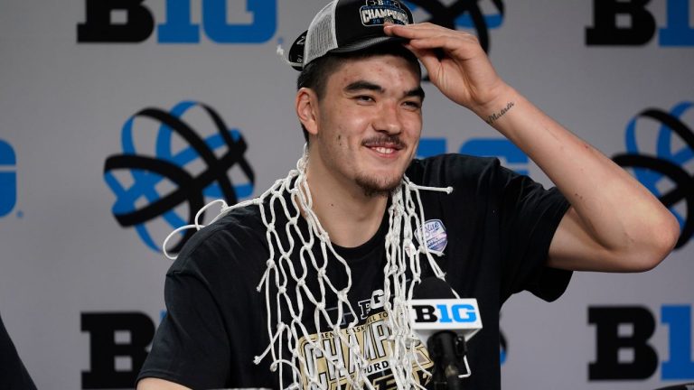 Purdue's Zach Edey wears the net around his neck during a news conference after his team's 67-65 win over Penn State to claim the Big Ten tournament championship in an NCAA college basketball game Sunday, March 12, 2023, in Chicago. (AP)