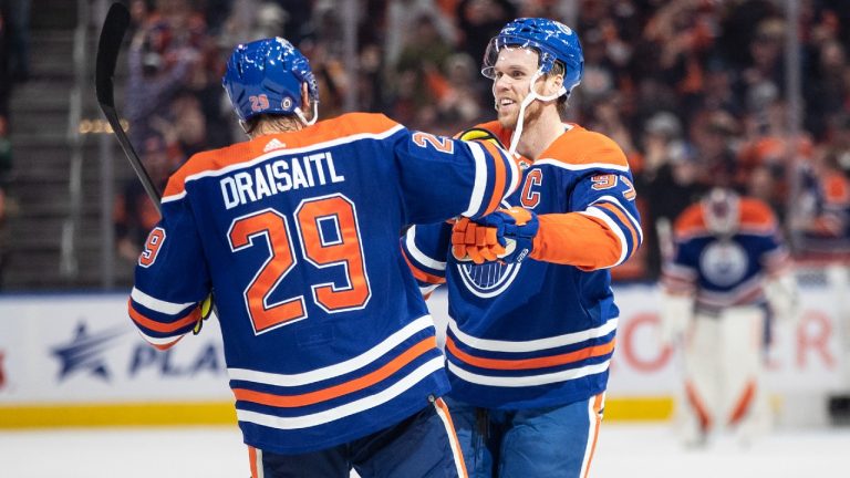 Edmonton Oilers' Connor McDavid (97) and Leon Draisaitl (29) celebrate a goal against the Arizona Coyotes during overtime NHL action in Edmonton on Wednesday March 22, 2023. (Jason Franson/CP)