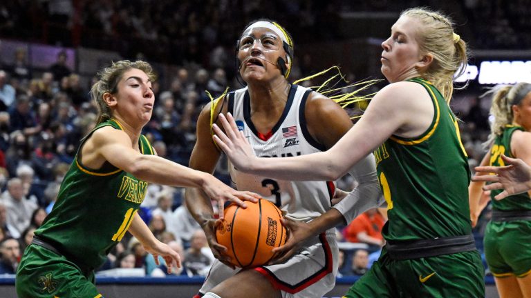 UConn's Aaliyah Edwards (3) drives between Vermont's Bella Vito, left, and Maria Myklebust, right, in the second half of a first-round college basketball game in the NCAA Tournament, Saturday, March 18, 2023, in Storrs, Conn. (Jessica Hill/AP)