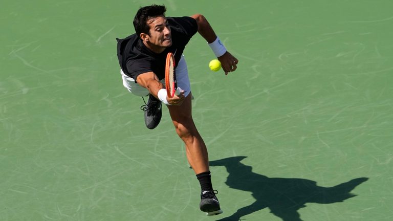 Cristian Garin, of Chile, returns a shot to Casper Ruud, of Norway, at the BNP Paribas Open tennis tournament Sunday, March 12, 2023, in Indian Wells, Calif. (Mark J. Terrill/AP)